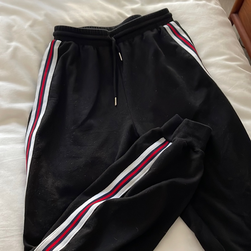 Black joggers with red stripes